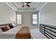 Neutral bedroom with carpet, ceiling fan, and tray ceilings at 919 Olmsted Ln, Johns Creek, GA 30097