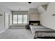 Cozy bedroom with plush carpet, ceiling fan, and large windows for natural light at 919 Olmsted Ln, Johns Creek, GA 30097