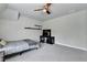 Cozy bedroom with plush carpet, ceiling fan, and large windows for natural light at 919 Olmsted Ln, Johns Creek, GA 30097