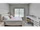 Bedroom with a window view and desk area presents a comfortable and functional design at 919 Olmsted Ln, Johns Creek, GA 30097