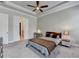 Neutral bedroom with carpet, ceiling fan, and tray ceilings at 919 Olmsted Ln, Johns Creek, GA 30097