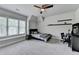 Cozy bedroom with plush carpet, ceiling fan, and large windows for natural light at 919 Olmsted Ln, Johns Creek, GA 30097