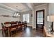 Dining area with seating for eight, hardwood flooring, and a stylish pendant light fixture at 919 Olmsted Ln, Johns Creek, GA 30097