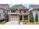 Charming brick home with manicured lawn, inviting front porch, and attached two-car garage at 919 Olmsted Ln, Johns Creek, GA 30097