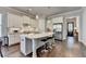 Bright kitchen featuring an island, stainless appliances, white cabinets and hardwood floors at 919 Olmsted Ln, Johns Creek, GA 30097