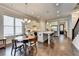 Bright open kitchen and dining area featuring an island, stainless appliances, white cabinets, hardwood floors, and a staircase at 919 Olmsted Ln, Johns Creek, GA 30097