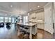 Open kitchen with an island, bar stool seating, and view into living area at 919 Olmsted Ln, Johns Creek, GA 30097