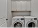 Laundry room featuring white cabinets and side-by-side washer and dryer at 919 Olmsted Ln, Johns Creek, GA 30097