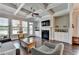 Bright living room features coffered ceilings, a ceiling fan, a fireplace, and hardwood floors at 919 Olmsted Ln, Johns Creek, GA 30097