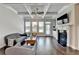 Bright living room featuring a fireplace, coffered ceilings, hardwood floors, and lots of natural light at 919 Olmsted Ln, Johns Creek, GA 30097