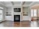 Comfortable living room with built-in shelving and a fireplace at 919 Olmsted Ln, Johns Creek, GA 30097