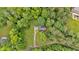 Aerial view of a charming home nestled among lush green trees, offering privacy and natural beauty at 144 Wiley Dr, Douglasville, GA 30134
