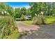 Long driveway leading to a well-maintained home with lush greenery and a carport at 144 Wiley Dr, Douglasville, GA 30134