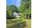 Traditional home with light siding, green lawn, and a beautiful surrounding landscape at 144 Wiley Dr, Douglasville, GA 30134