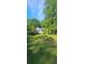 Charming home exterior featuring a well-manicured lawn and mature trees at 144 Wiley Dr, Douglasville, GA 30134