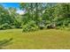 Spacious front yard with mature trees, providing a beautiful and serene setting for the home at 144 Wiley Dr, Douglasville, GA 30134