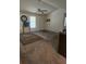 Spacious living room with neutral carpeting, a ceiling fan, and ample natural light at 144 Wiley Dr, Douglasville, GA 30134