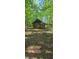 Rustic wooden outbuilding nestled in a wooded area at 144 Wiley Dr, Douglasville, GA 30134