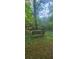 Park bench in a wooded area, perfect for nature lovers or relaxation at 144 Wiley Dr, Douglasville, GA 30134