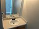 Half bathroom with a single sink vanity and a framed mirror at 3702 Gray Birch Dr, Decatur, GA 30034