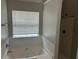 Bathroom featuring a soaking tub with a tile surround and a glass door shower at 3702 Gray Birch Dr, Decatur, GA 30034