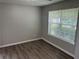 Neutral bedroom with gray walls, hardwood floors, a large window, and natural light at 3702 Gray Birch Dr, Decatur, GA 30034