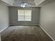 This bedroom features neutral walls and carpet, a ceiling fan, and tray ceilings at 3702 Gray Birch Dr, Decatur, GA 30034