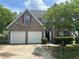 A brick two-story home with a two car garage and traditional architectural details at 3702 Gray Birch Dr, Decatur, GA 30034