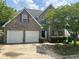 Charming two-story brick home featuring a two-car garage, landscaped front yard and traditional architectural details at 3702 Gray Birch Dr, Decatur, GA 30034