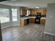 Bright eat-in kitchen with black appliances, oak cabinets, tile backsplash, and laminate floors at 3702 Gray Birch Dr, Decatur, GA 30034
