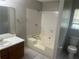 Well-lit bathroom with a combined tub and shower, plus wood-finished vanity and tiled floor at 5340 Forest Pl, Stone Mountain, GA 30088