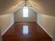 Bedroom featuring a ceiling fan, wood-look flooring, and natural light from the window at 5340 Forest Pl, Stone Mountain, GA 30088