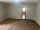 Bedroom with a doorway leading to another room, and carpeted flooring at 5340 Forest Pl, Stone Mountain, GA 30088