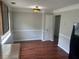 Dining room featuring neutral paint, laminate flooring and a decorative light fixture at 5340 Forest Pl, Stone Mountain, GA 30088
