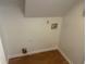 Laundry room with hardwood flooring and connections for a washer and dryer at 5340 Forest Pl, Stone Mountain, GA 30088