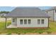 Backyard with a covered patio and well-maintained lawn at 6908 Winchester Pl, Fairburn, GA 30213