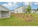 Beautiful backyard showing the side and back of the home featuring a small tree and grass at 6908 Winchester Pl, Fairburn, GA 30213