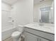 Bathroom features a bathtub with shower, toilet, and single sink vanity with white countertop at 6908 Winchester Pl, Fairburn, GA 30213