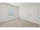 This carpeted bedroom has natural light from a window at 6908 Winchester Pl, Fairburn, GA 30213