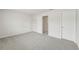 Bedroom featuring neutral paint, carpeted floors, two doors, and a closet for storage at 6908 Winchester Pl, Fairburn, GA 30213