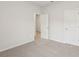 Neutral bedroom featuring new carpet, white walls, and a double door closet at 6908 Winchester Pl, Fairburn, GA 30213