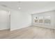 Bright bedroom with three large windows, neutral walls, recessed lighting, and wood grain flooring at 6908 Winchester Pl, Fairburn, GA 30213