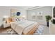 This staged bedroom has a large bed, modern decor, and natural light at 6908 Winchester Pl, Fairburn, GA 30213