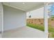 Open-air covered patio featuring a neutral concrete floor and views of the property grounds at 6908 Winchester Pl, Fairburn, GA 30213