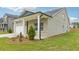 Single Gathering home featuring light brick, white trim, covered porch, and a well manicured lawn at 6908 Winchester Pl, Fairburn, GA 30213