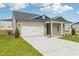 Attractive single Gathering home featuring light brick, white trim, and an attached two car garage at 6908 Winchester Pl, Fairburn, GA 30213