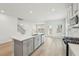 Open-concept kitchen with gray cabinets, a center island, and stainless steel appliances at 6908 Winchester Pl, Fairburn, GA 30213