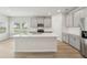 Modern kitchen featuring an island, stainless steel appliances, and light gray cabinets at 6908 Winchester Pl, Fairburn, GA 30213