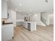 Spacious kitchen featuring stainless steel appliances, center island, and adjacent staircase at 6908 Winchester Pl, Fairburn, GA 30213