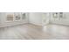 Bright living room with wood grain floors, and ample natural light at 6908 Winchester Pl, Fairburn, GA 30213